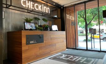 The front desk and restaurant entrance have glass doors that provide an outside view at CHECK inn Taipei Songjiang