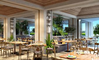 a modern restaurant with wooden tables , chairs , and potted plants , creating a warm and inviting atmosphere at DoubleTree Resort by Hilton Hotel Penang