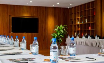 a conference room set up for a meeting , with bottles of water and cups on the table at Alba Wellness Resort by Fusion