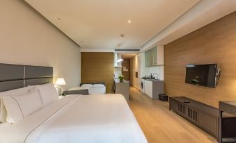 The modern bedroom features a spacious layout with double beds and an adjoining living area at the Westin Xi'an