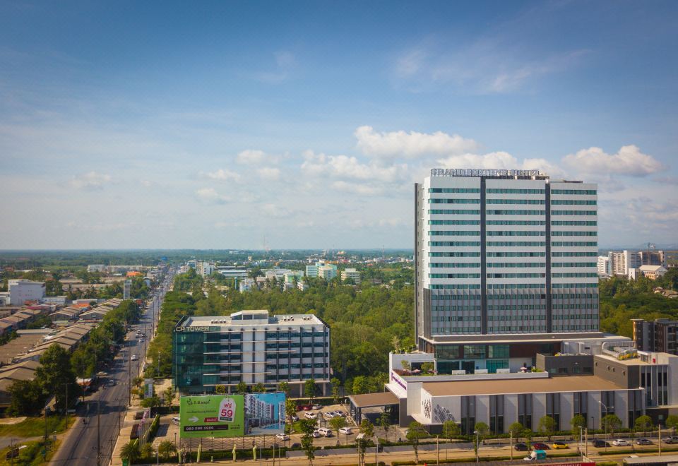a modern cityscape with a tall building in the foreground and other buildings in the background at Grand Fortune Hotel Nakhon Si Thammarat