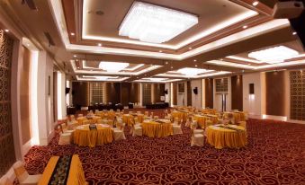 a large , well - lit banquet hall with multiple tables and chairs set up for a formal event at Bromo Park Hotel Probolinggo