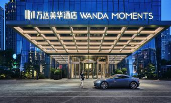 "At night, there is an illuminated sign above the entrance to a hotel that says ""I love" at Wanda Moments