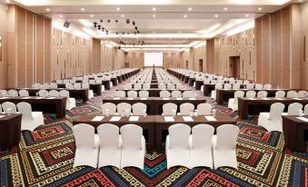 a large conference room with rows of chairs arranged in a semicircle around a long table at Aston Kupang Hotel & Convention Center