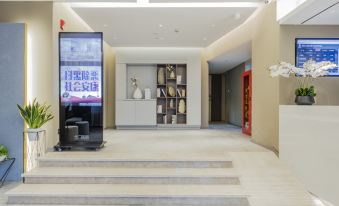 The room entrance features a large screen TV mounted on the wall and a tiled floor in front at Neo Shanghai Nanjing Road Pedestrian Street Huanghe Road Store