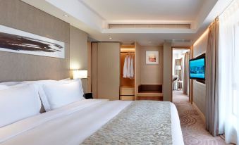 The middle room features a spacious bed, an attached bathroom, and a sitting area adjacent to it at The Royal Garden Hotel