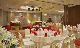 a large banquet hall with multiple tables and chairs , set for a formal event or celebration at Pearl View Hotel Prai, Penang
