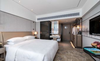 A modern bedroom in the main area with a large bed and white furnishings is available at Hotel Landmark Canton Guangzhou