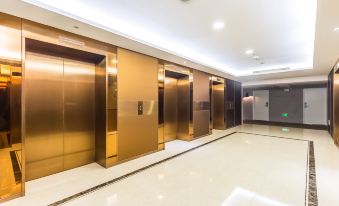 A spacious second-floor office with an elevator and multiple doors at Moka Apartment (Guangzhou CUHK Cancer Hospital Taojin Subway Station)