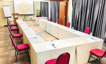 a conference room with long tables and chairs arranged in a semicircle , creating an intimate setting for a meeting at Sem9 Senai "Formerly Known As Perth Hotel"
