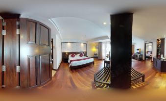 a 3 6 0 - degree panoramic view of a hotel room with a king - sized bed , a tv , and a bathroom at Tara Angkor Hotel
