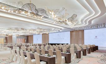 A spacious room is arranged with tables and chairs for hosting events at the hotel or conference at Nina Hotel Tsuen Wan West