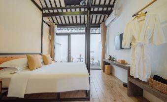 a modern bedroom with a large bed , white linens , and a tv mounted on the wall at yhz