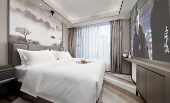 The top floor level features a modern bedroom with large windows and a white bed in the middle at Mumian Hotel (Guangzhou Baiyun International Airport)