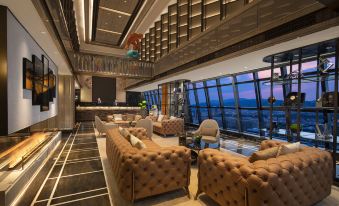 The living room on the upper floor offers a breathtaking view of the city, with comfortable couches and chairs at Kasion K Hotel Yiwu