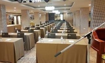 a large conference room filled with rows of chairs and tables , ready for a meeting or event at Soho Boutique Hotel