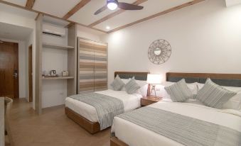 a modern hotel room with two beds , white bedding , and wooden headboards , along with a ceiling fan and nightstand at Thunderbird Resorts - Rizal