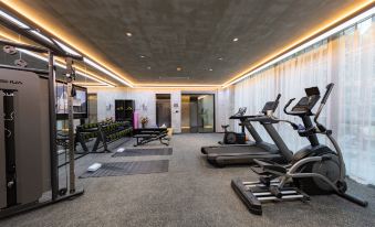 The room is spacious and contains multiple exercise equipment, as well as an indoor gym area at Atour S Hotel