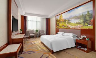 a modern hotel room with a white bed , large window , and abstract artwork on the wall at Mediterranean Hotel