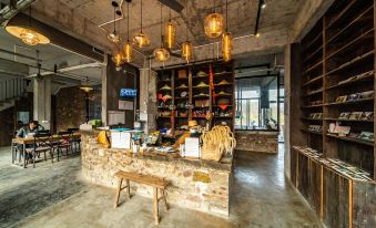 The interior of the establishment has a rustic design, featuring a bar and seating area at the front at Yangshuo Sudder Street Guesthouse