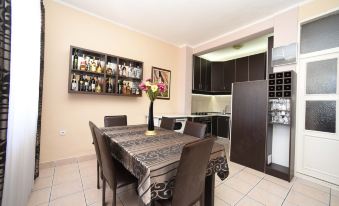 a well - equipped kitchen with a dining table and chairs , as well as a living room area at D&D Apartments