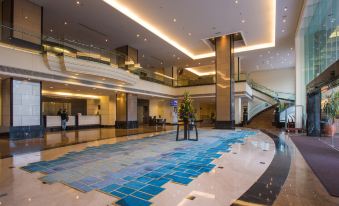 a large hotel lobby with a marble floor , a staircase , and a blue mosaic floor at Concorde Hotel Shah Alam