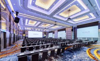 A spacious room with tables and chairs is arranged for hosting events or conferences at Grande Centre Point Space Pattaya