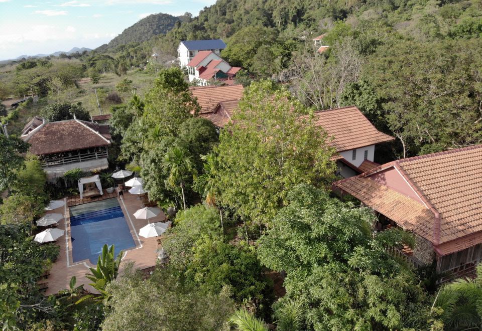 a bird 's eye view of a resort nestled in the mountains with a pool and outdoor seating areas at Tara Lodge Haven of Peace