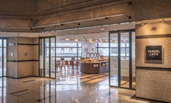 a modern hotel lobby with marble floors , glass doors , and a view of the kitchen at HOTEL MYSTAYS Utsunomiya