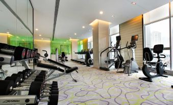 There is a spacious room with multiple exercise equipment and an indoor fitness center located in the center at Sofitel Guangzhou Sunrich