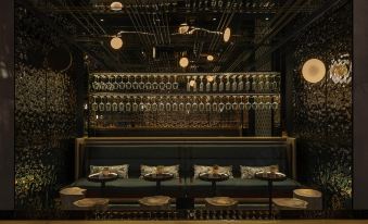 The room is decorated in blue hues and contains tables and chairs along the wall at URBN Boutique Shanghai
