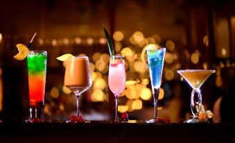 There is a variety of drinks, including alcoholic beverages, available on the table at an event or party at B P International