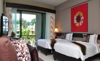 a hotel room with two beds , a couch , and a window overlooking a beautiful view at Poonyamantra Resort