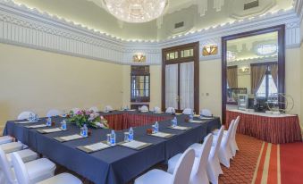A spacious room is arranged with long tables and chairs for events or functions at Okura Garden Hotel Shanghai