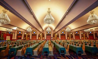 A spacious ballroom is arranged with rows of tables for an event or function at Ambassador Hotel Bangkok