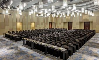 a large conference room with rows of chairs arranged in a semicircle , providing seating for a large group of people at Melia Vinpearl Hue