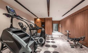 The home features a spacious living area with a large gym for exercising at UrCove by HYATT Shanghai Jing'an