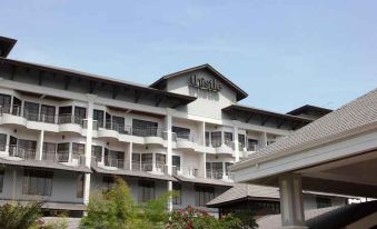 "a large , white hotel building with the name "" century park "" on it , surrounded by trees and a clear blue sky" at Thistle Port Dickson Resort