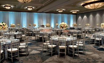 a large banquet hall with multiple round tables and chairs arranged for a formal event at Bethesda North Marriott Hotel & Conference Center