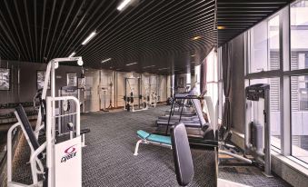 There is a spacious room with multiple exercise equipment and an indoor fitness center located in the center at Central Hotel Shanghai
