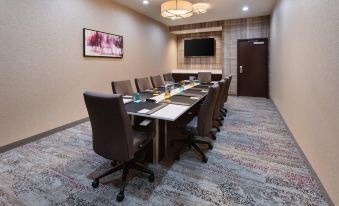 a conference room with a long table , chairs , and a tv mounted on the wall at Courtyard Pittsburgh Washington/Meadow Lands