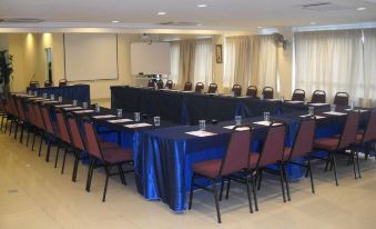 a conference room with a long table set up for a meeting , surrounded by chairs at Sun Inns Hotel Kuala Selangor