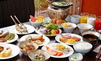 a dining table filled with a variety of food items , including bowls , plates , and utensils at Hotel Resol Gifu
