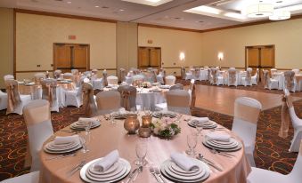 a well - decorated banquet hall with multiple tables set up for a formal event , each table having its own unique centerpiece and set for at DoubleTree by Hilton Hotel Grand Junction