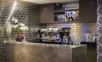 a modern coffee shop with a long marble counter , surrounded by various cups and bottles on display at The Hide London