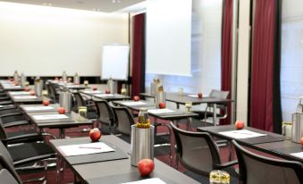 a classroom setting with rows of desks and chairs arranged for a classroom or meeting at Mercure Villeneuve Loubet Plage