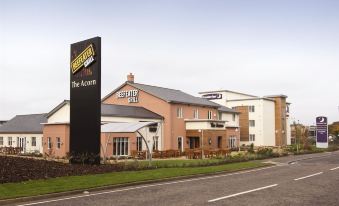 "a large hotel building with a sign that reads "" the acorn "" on the side of the building" at Premier Inn Burgess Hill