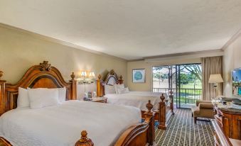 a hotel room with two beds , one on the left and one on the right side of the room at Mission Inn Resort & Club