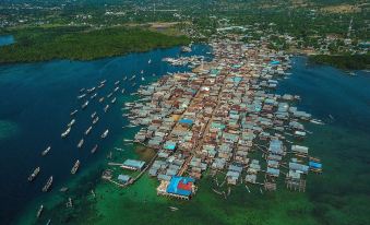 aerial view of a small town surrounded by water , with boats floating on the water at Coconut Garden Beach Resort