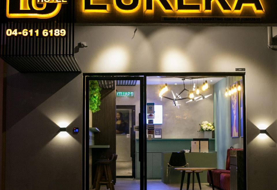 "the entrance to a hotel with a neon sign that says "" eureka "" and a mirror inside" at Eureka Hotel Penang